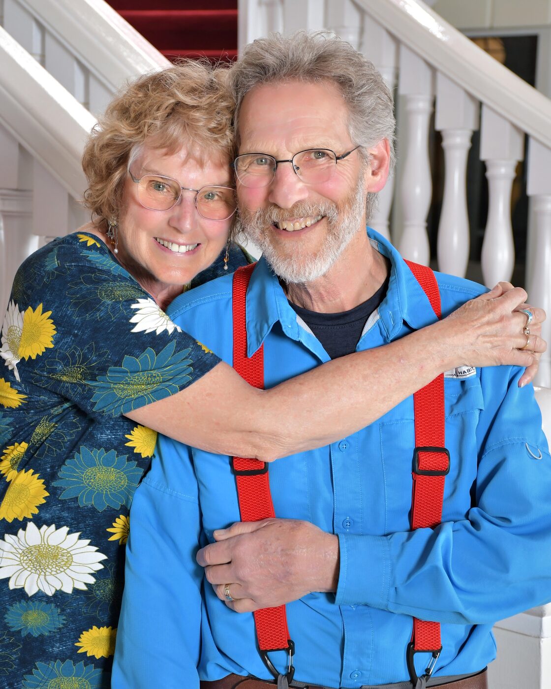 Couple embracing on the ship's grand staircase, formal night portrait