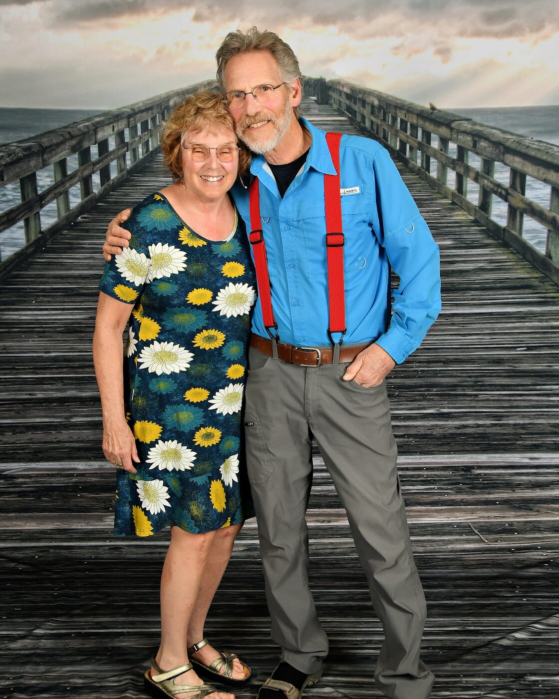 Couple standing on a wooden pier backdrop