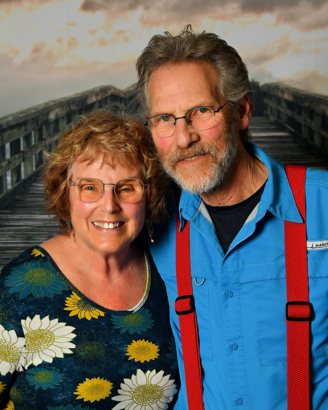 Close portrait of a couple on the pier backdrop